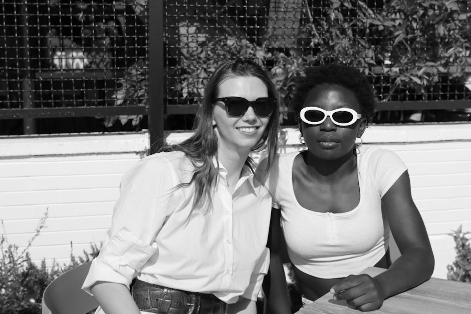 Charming black and white portrait of two friends enjoying a sunny day in Venice, Italy.
