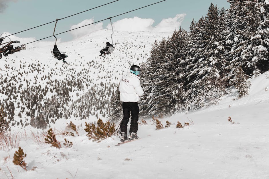 A skier stands on a snowy slope in Brezovica, Serbia, with ski lifts in the background.