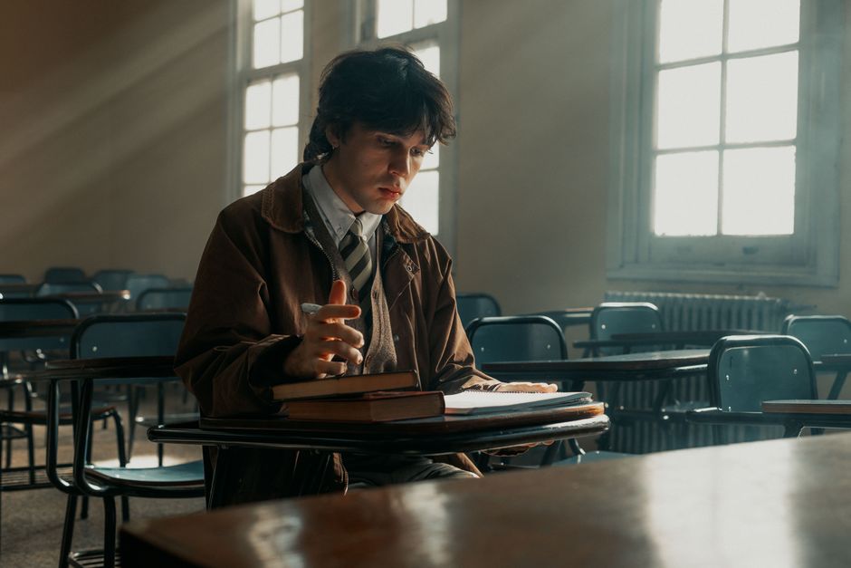 A thoughtful student studies in a sunlit classroom in Buenos Aires, capturing a moment of concentration.