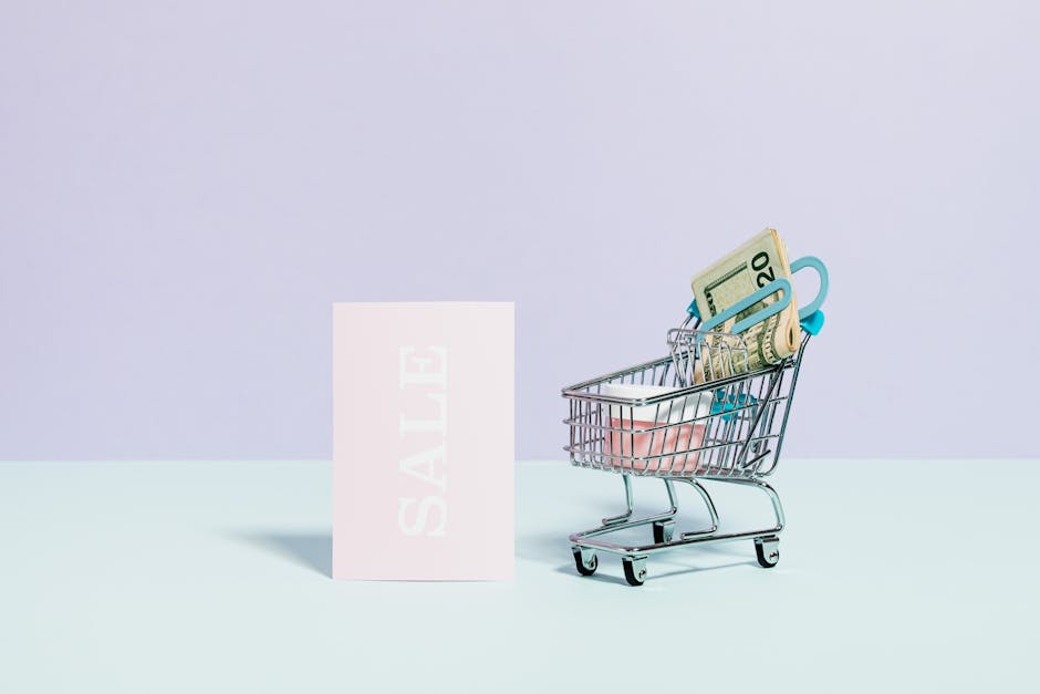 Mini shopping cart with cash alongside a sale sign on a pastel background, perfect for online shopping themes.
