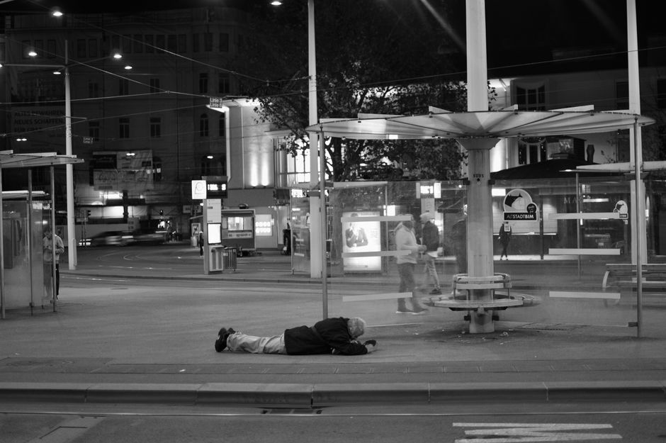 A dramatic night scene in black and white at a bus stop in Graz, Austria.